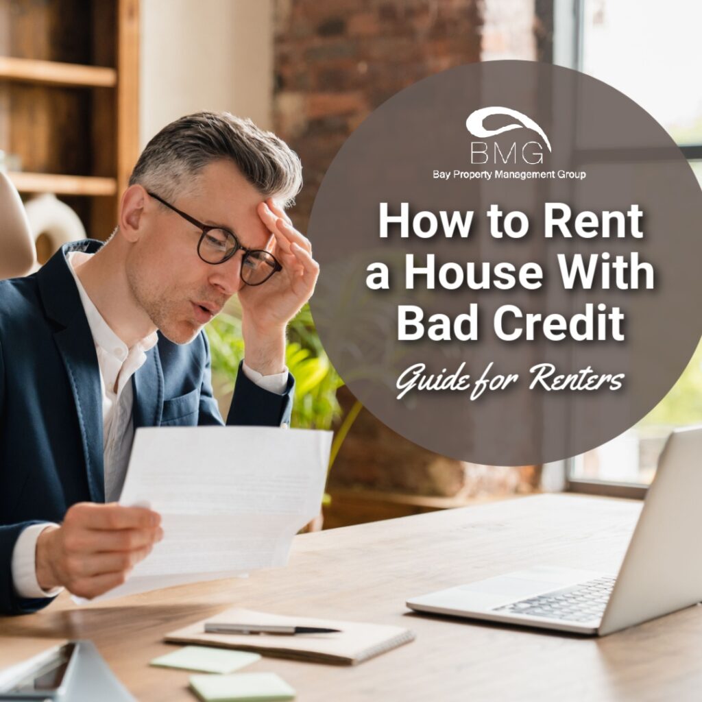 The image shows a concerned man in a suit, reading a document at a desk with a laptop. A circular overlay displays the Bay Property Management Group logo and the text "How to Rent a House With Bad Credit: Guide for Renters."
