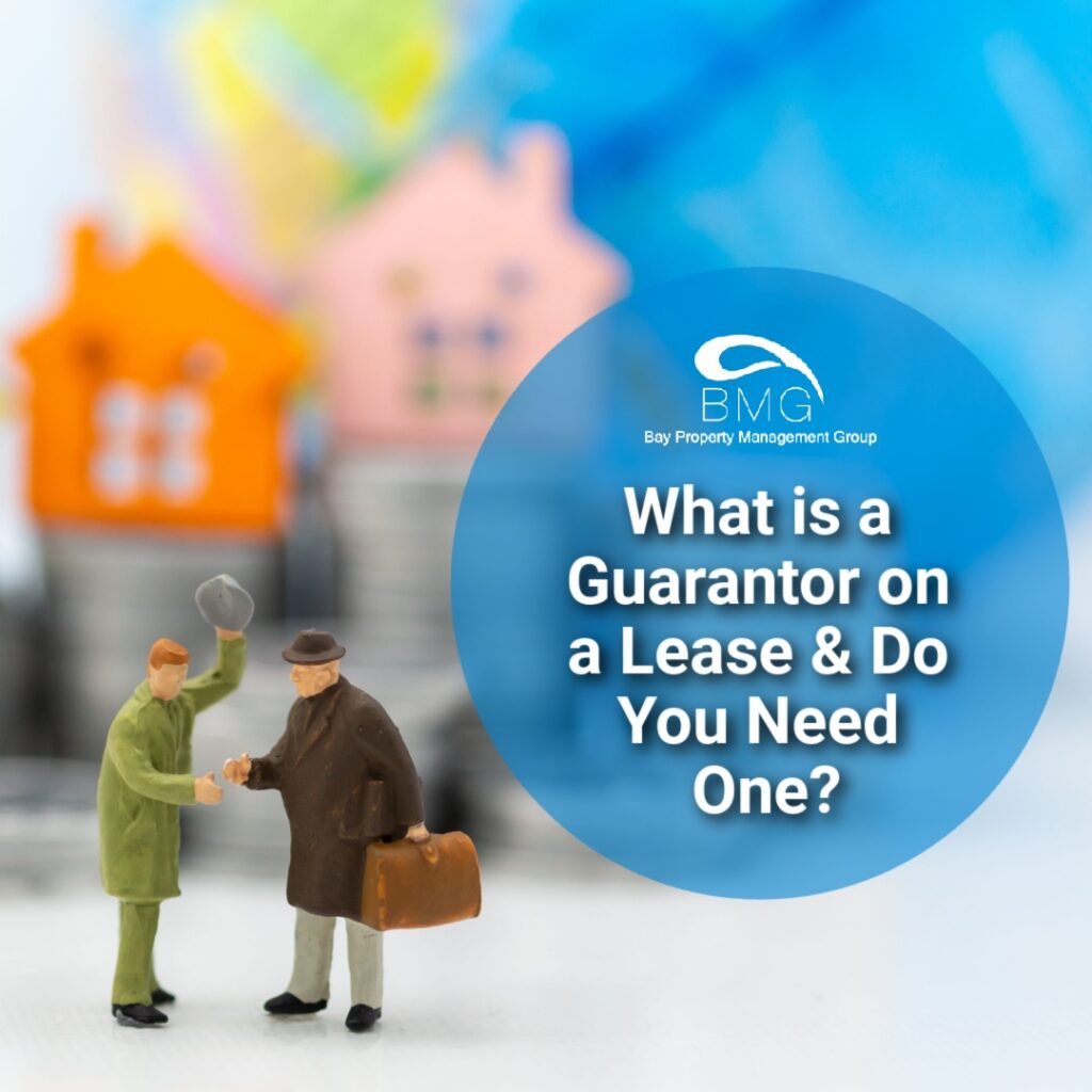 Image of two miniature figures shaking hands in front of colorful house models. Text overlay: 'What is a Guarantor on a Lease & Do You Need One?'